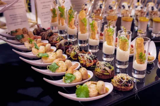 Elegancki catering na wesele: krewetki, mini kanapeczki i przekąski w kieliszkach.